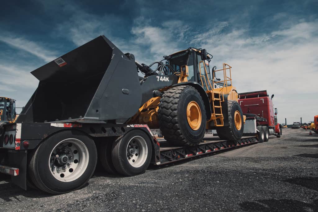  A lowboy trailer hauling a wheel loader.