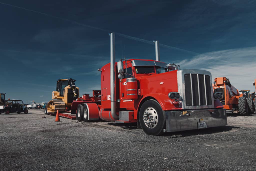 Truck hauling dozer