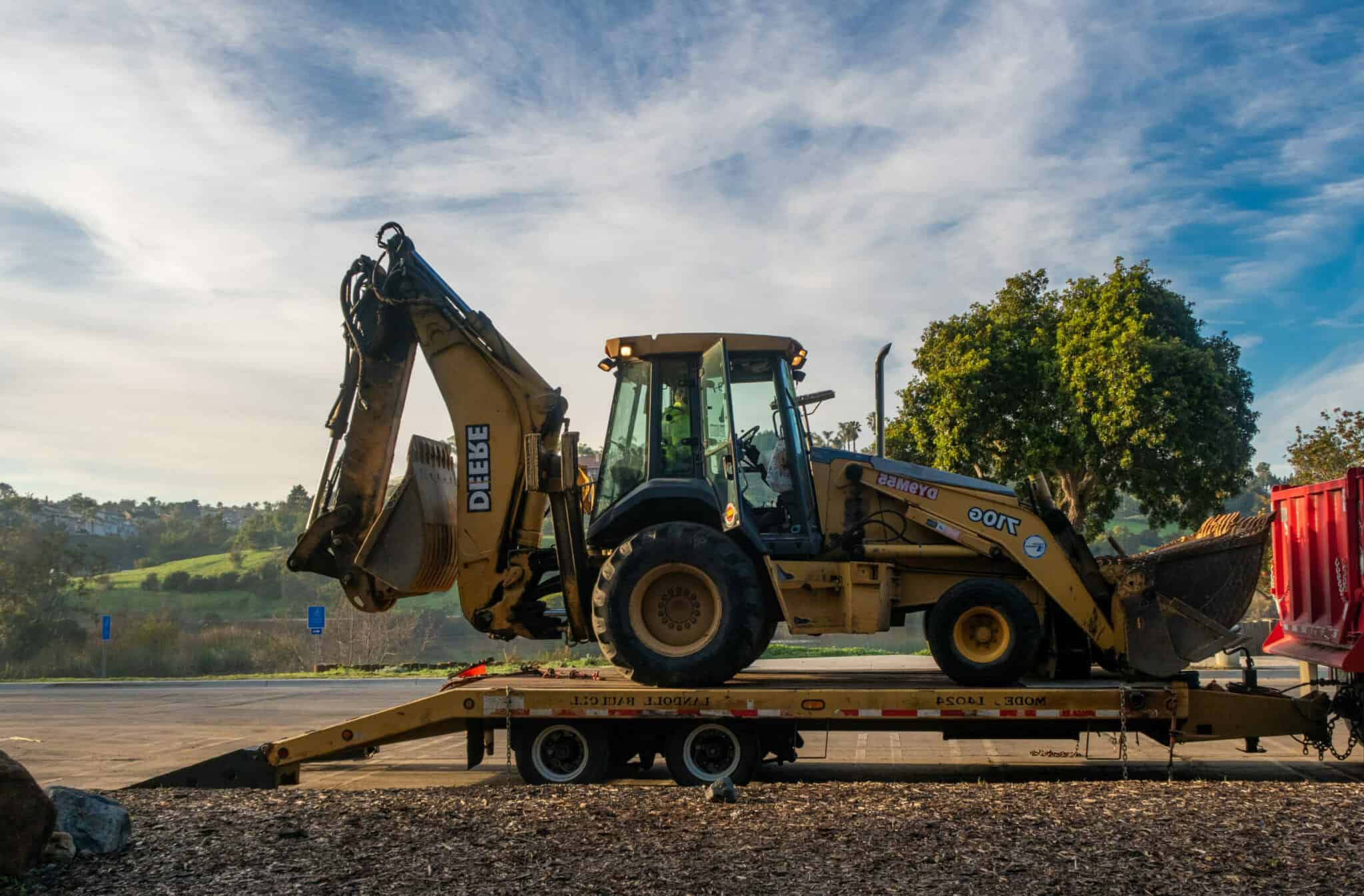 loader backhoe on trailer