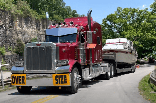 semi hauling boat